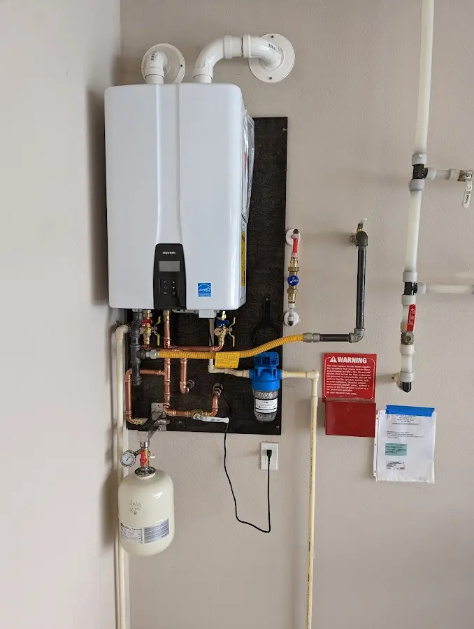 Professional plumber installing copper piping in a Huguley home